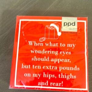 This image shows a red cocktail napkin with a humorous holiday-themed poem